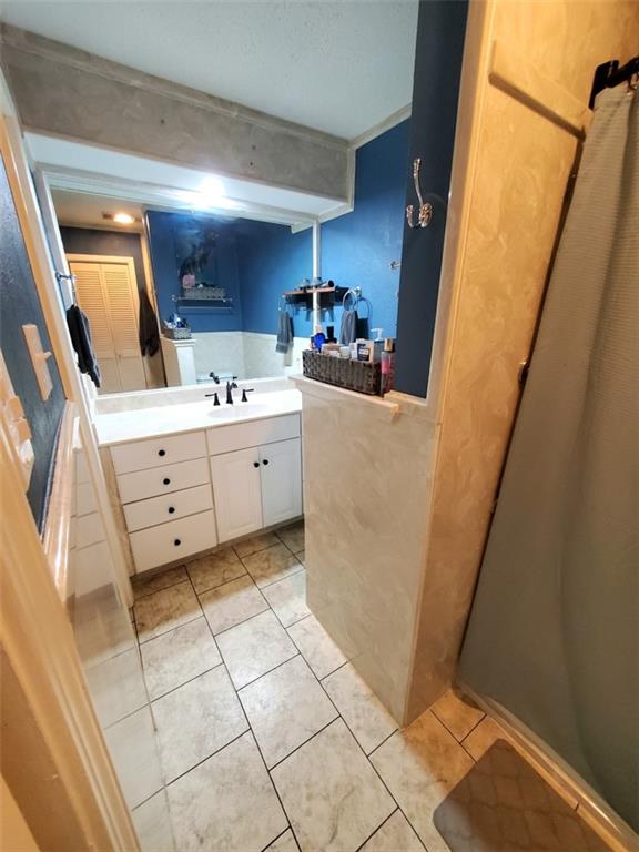 bathroom with tile patterned floors and vanity