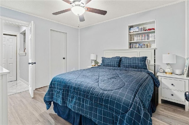 9028 Camille Ave, River Ridge, LA 70123 - bedroom with ceiling fan, a textured ceiling, light wood-style flooring, and ornamental molding