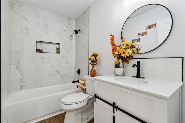 full bathroom featuring vanity, toilet, tiled shower / bath combo, and hardwood / wood-style floors