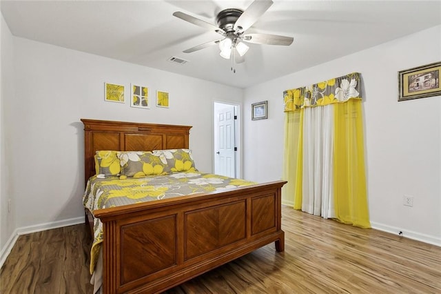 bedroom with hardwood / wood-style floors and ceiling fan