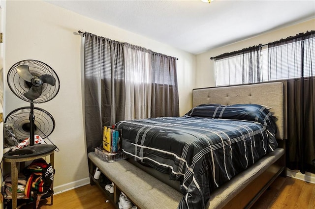 bedroom with dark hardwood / wood-style flooring