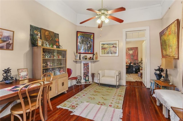 living area with dark hardwood / wood-style floors and ceiling fan