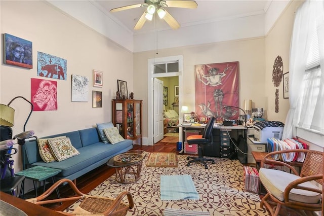 living area with ceiling fan, ornamental molding, and hardwood / wood-style floors