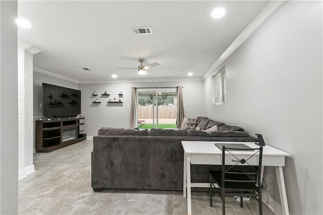 living room with crown molding and ceiling fan