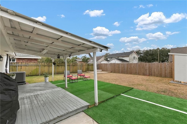 view of yard with cooling unit and a wooden deck