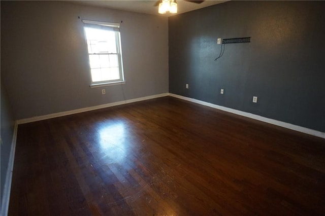 empty room with ceiling fan and dark hardwood / wood-style floors