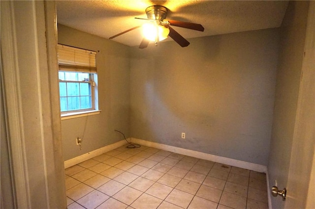 empty room with ceiling fan and light tile patterned flooring