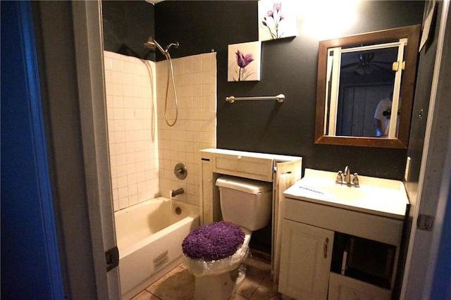 full bathroom with tiled shower / bath, vanity, toilet, and tile patterned flooring