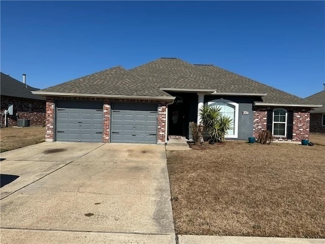 ranch-style house with a garage and central AC unit