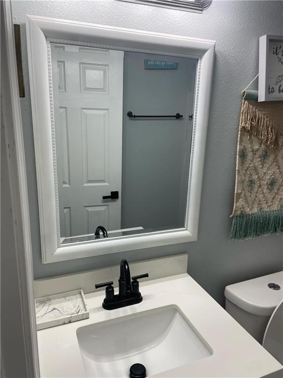 bathroom featuring vanity and toilet