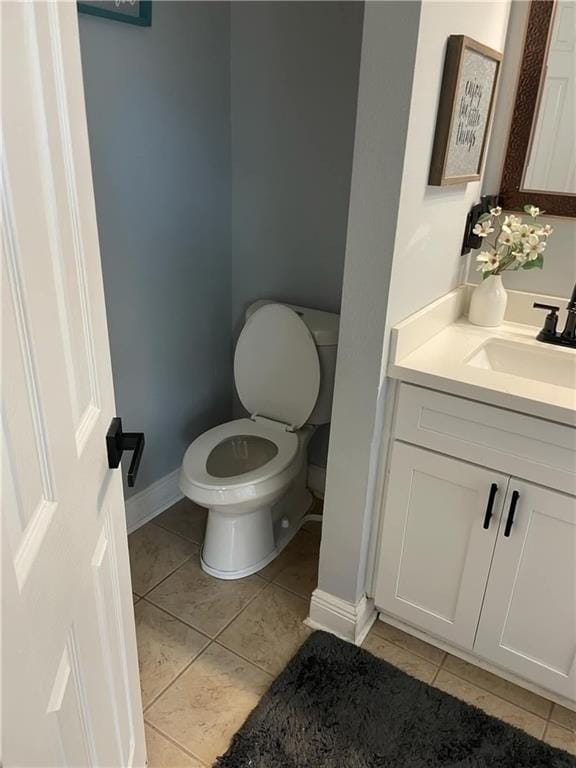 bathroom with tile patterned flooring, vanity, and toilet