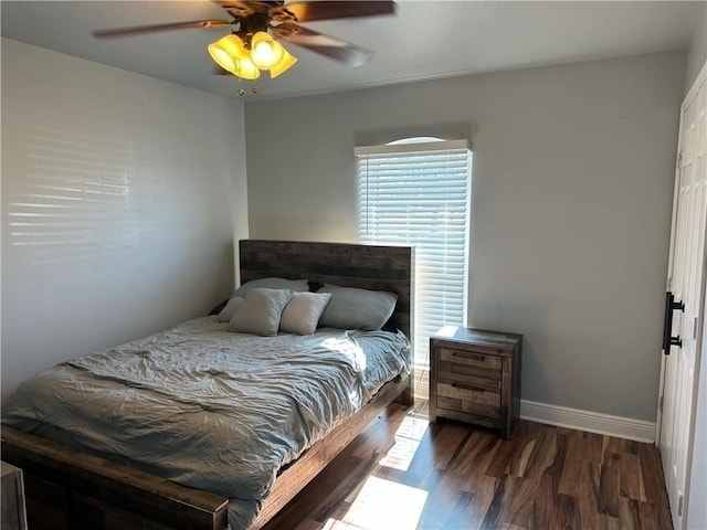 bedroom with ceiling fan and dark hardwood / wood-style floors