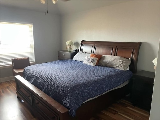 bedroom with dark hardwood / wood-style floors