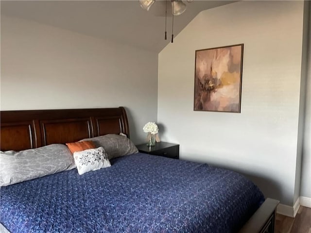 bedroom with hardwood / wood-style flooring and vaulted ceiling