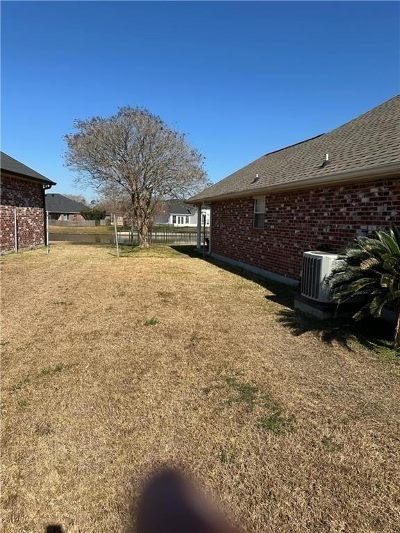 view of yard with central AC