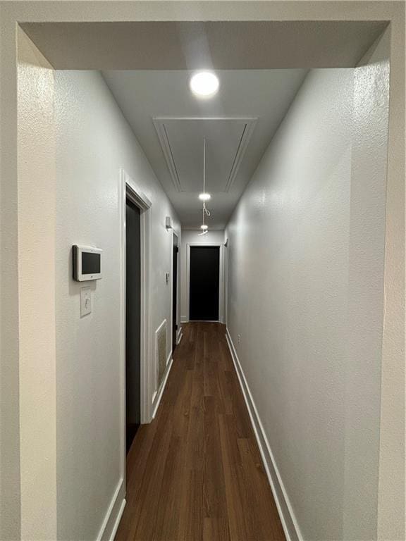 corridor with dark wood-type flooring