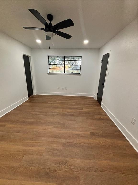 empty room with ceiling fan and hardwood / wood-style floors