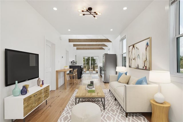 living room featuring beamed ceiling and light hardwood / wood-style flooring