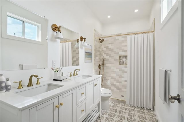 bathroom featuring tile patterned flooring, vanity, curtained shower, and toilet