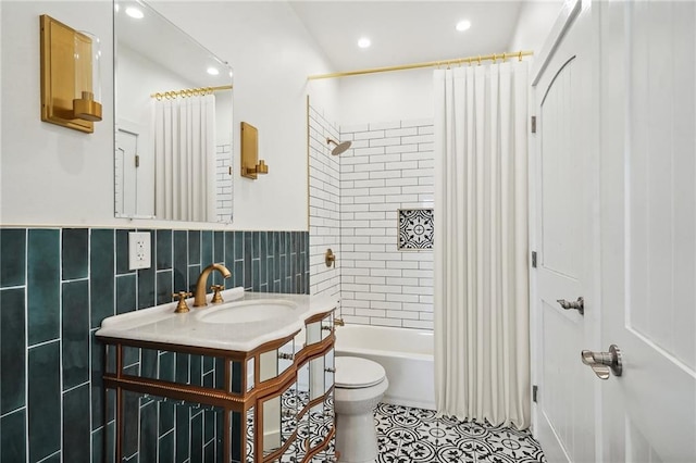 full bathroom featuring sink, tile walls, tile patterned flooring, toilet, and shower / bath combo