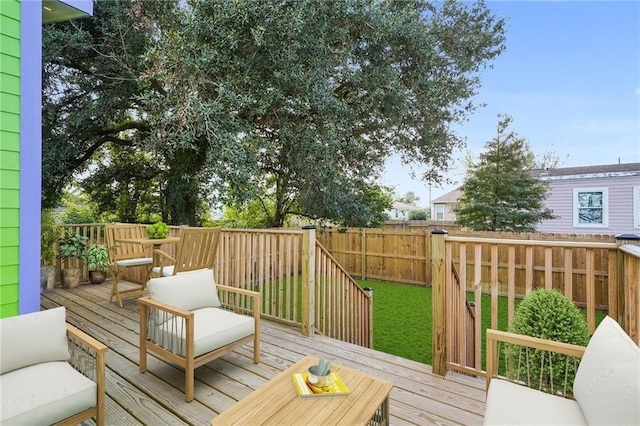 wooden deck featuring a yard