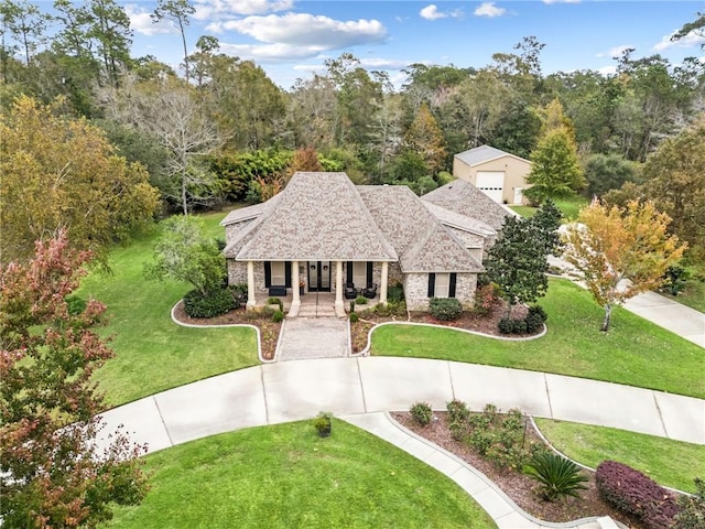 view of front of home with a front yard and covered porch