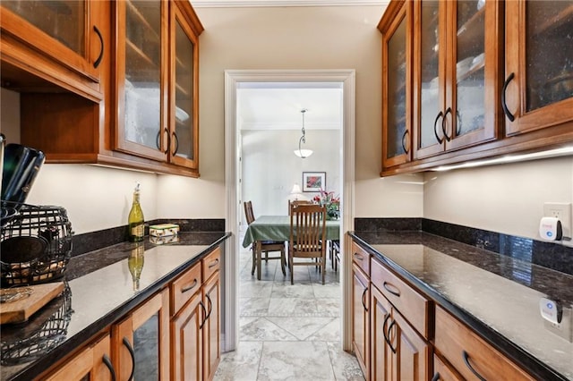 kitchen featuring hanging light fixtures and dark stone counters