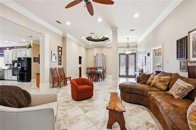 living room featuring crown molding, ceiling fan, french doors, and ornate columns