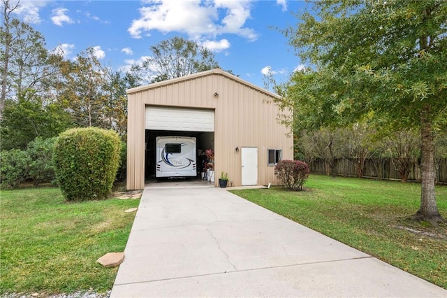 view of outdoor structure with a garage and a yard