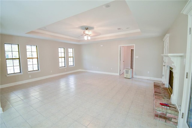 unfurnished living room with crown molding, ceiling fan, a fireplace, and a raised ceiling