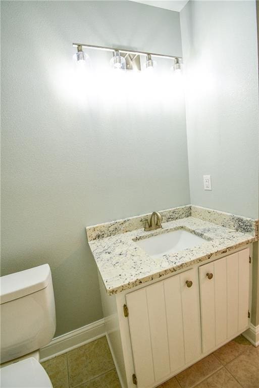 bathroom with vanity, tile patterned floors, and toilet