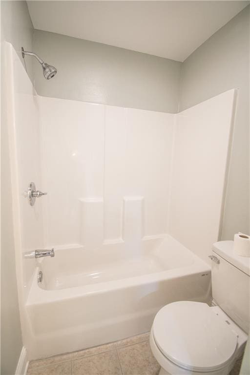 bathroom featuring toilet, tile patterned floors, and  shower combination