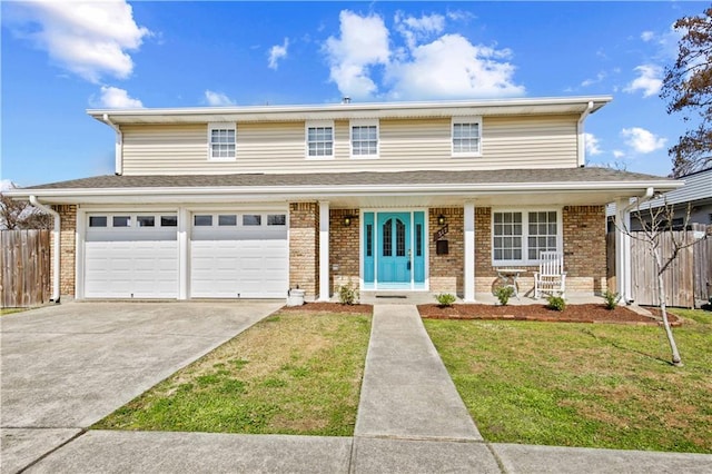 front of property with a garage, a front lawn, and covered porch