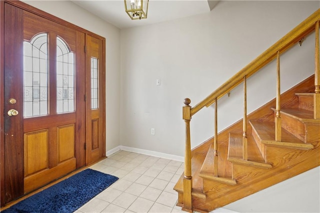 entrance foyer featuring light tile patterned floors and a chandelier