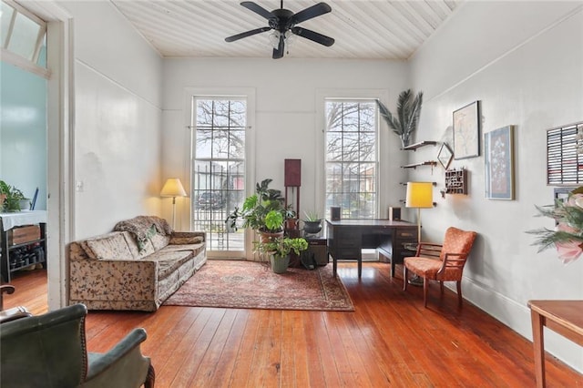 living area featuring wood ceiling, hardwood / wood-style flooring, and ceiling fan