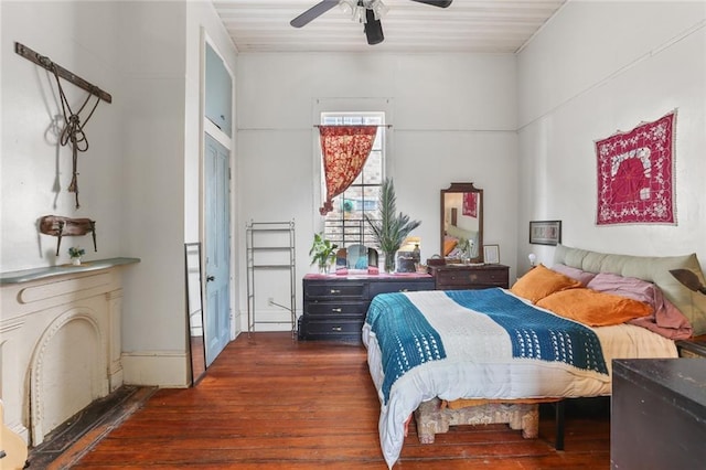 bedroom with ceiling fan and dark hardwood / wood-style flooring