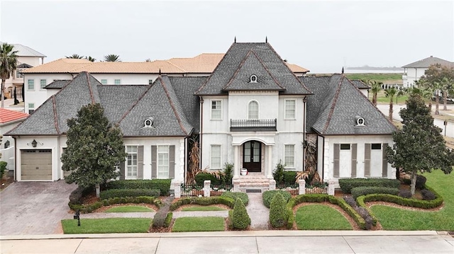 french country style house with a garage