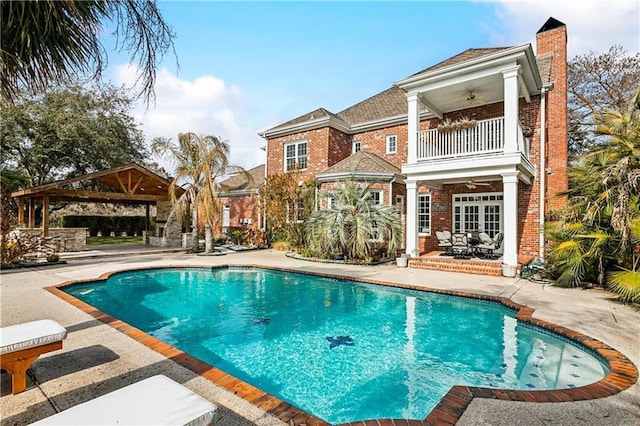 view of pool with a gazebo, ceiling fan, and a patio area