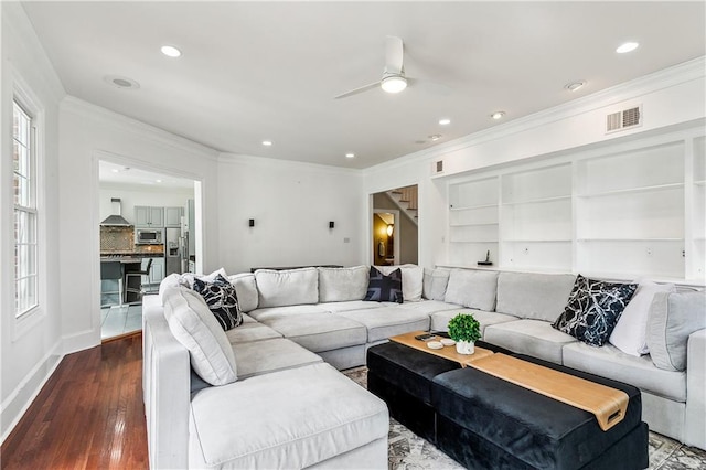 living room featuring crown molding, hardwood / wood-style floors, and ceiling fan