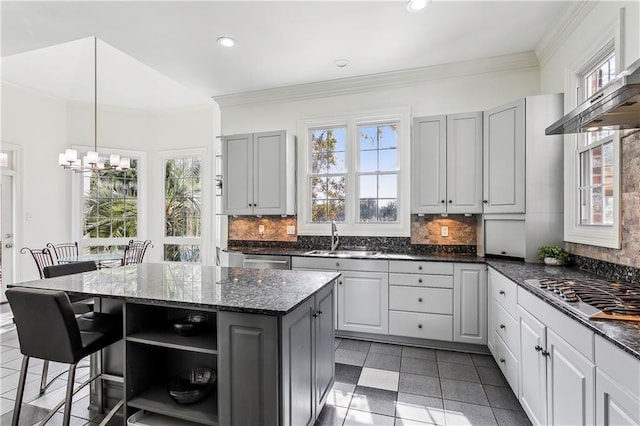 kitchen with a kitchen island, decorative light fixtures, sink, gray cabinetry, and stainless steel gas cooktop