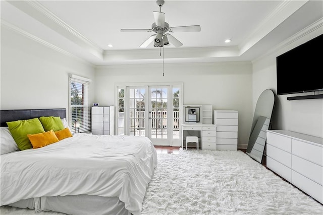 bedroom featuring french doors, ornamental molding, a tray ceiling, ceiling fan, and access to exterior