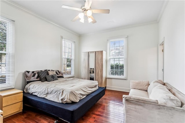 bedroom with dark hardwood / wood-style flooring, crown molding, multiple windows, and ceiling fan