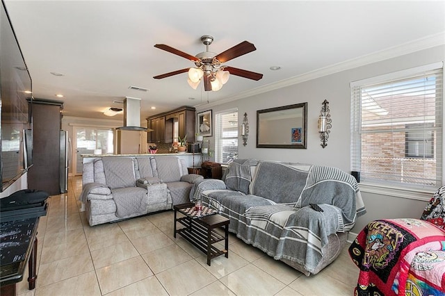 tiled living room featuring ornamental molding and ceiling fan