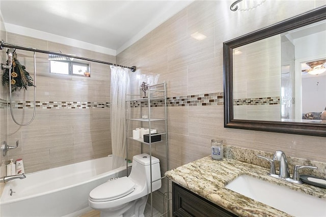 full bathroom featuring vanity, tile walls, shower / bathtub combination with curtain, and toilet