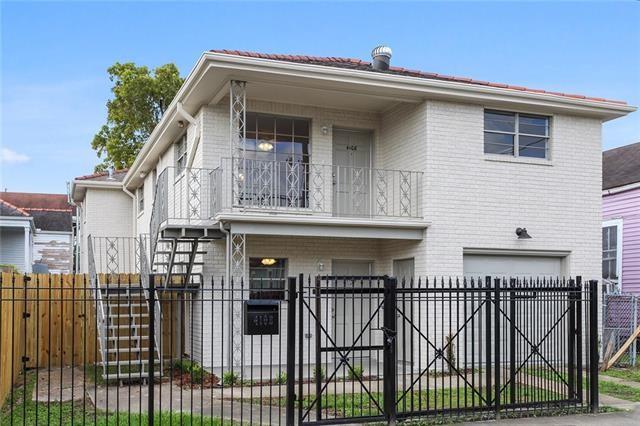 view of front of home with a garage and a balcony