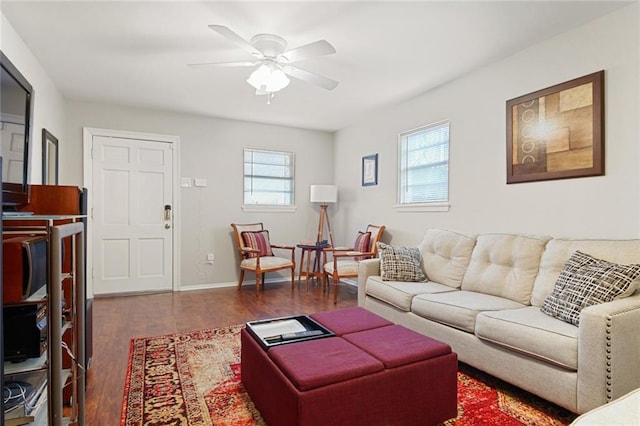 living room with dark wood-type flooring and ceiling fan