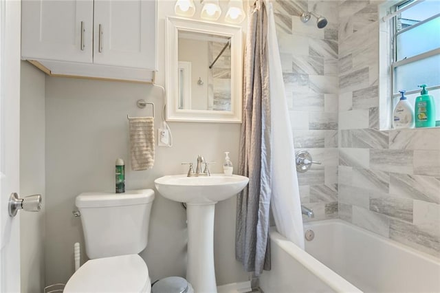 full bathroom with toilet, shower / bathtub combination with curtain, and sink