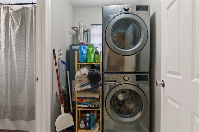 laundry room with stacked washing maching and dryer