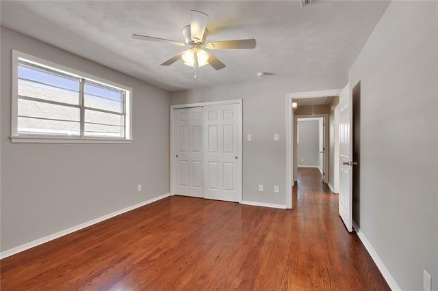 unfurnished bedroom featuring ceiling fan, dark hardwood / wood-style floors, and a closet