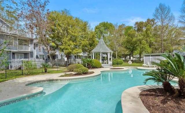 view of pool featuring fence, a fenced in pool, and a gazebo